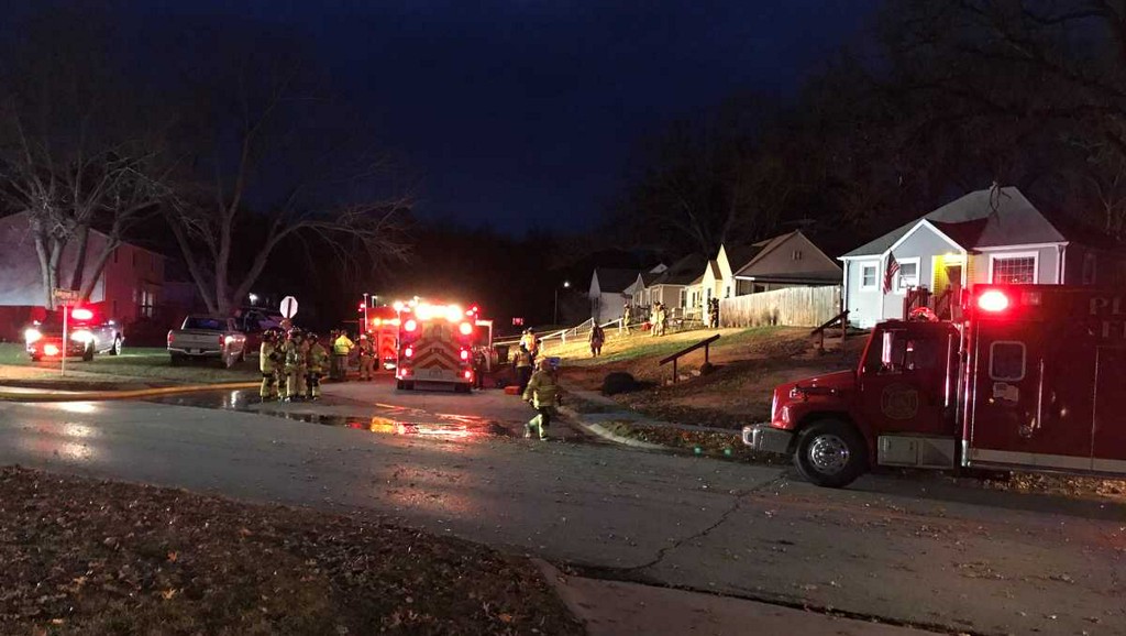 Firefighters rescued a woman from her burning home after a police officer spotted smoke pouring out of a home  Wednesday.